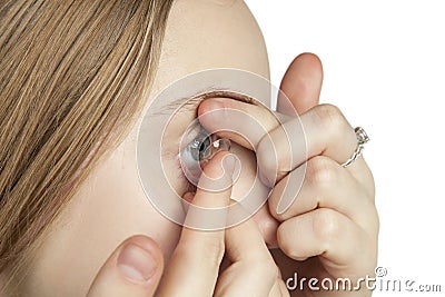 A young girl inserts contact lenses Stock Photo