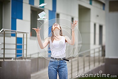 Girl catches falling euro banknotes Stock Photo