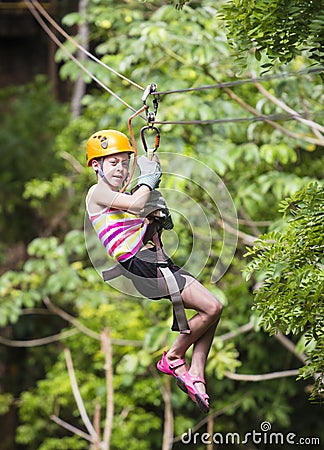 Young girl on a jungle zipline Stock Photo