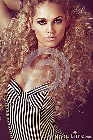 Young girl with long curly blond hair. Stock Photo