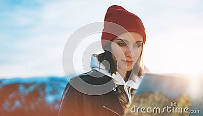 Young girl look and hold in hands map, person planning trip, hipster tourist on background sun flare nature, enjoy journey land Stock Photo