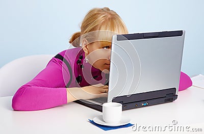 Young girl - is looking closely at laptop monitor Stock Photo