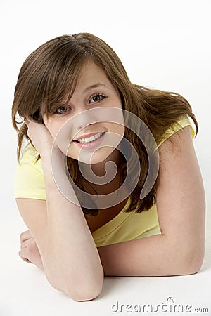 Young Girl Lying On Stomach In Studio Stock Photo