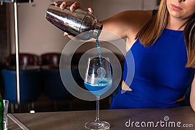 Artistry in a Glass: The Making of a Blue Lagoon Cocktail Stock Photo