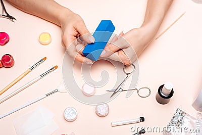 A young girl makes a manicure at home. Modern way of life. Stock Photo