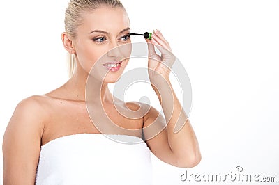Young girl mascaras her eyelashes in bathroom. Stock Photo