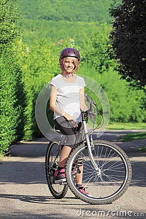 Young girl mountain biking Stock Photo