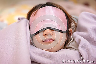 Young Girl Naps with an Eye Patch and a Cozy Blanket Stock Photo