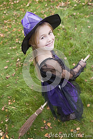 Young girl outdoors in witch costume on Halloween Stock Photo