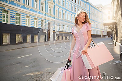 Fashionably dressed woman on the streets of a small town, shopping concept Stock Photo