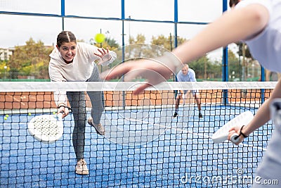 Young girl paddle tennis player performing forehand Stock Photo