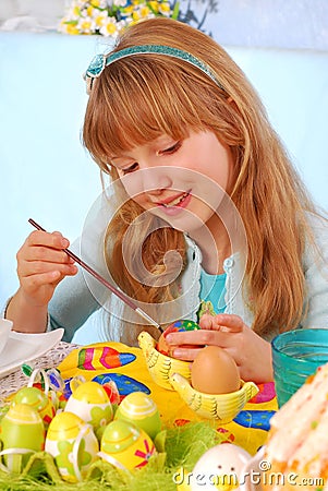 Young girl painting easter eggs Stock Photo