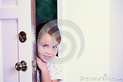 Young girl peeking into new house. Stock Photo