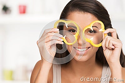 Young girl with peper slices on white background. Stock Photo