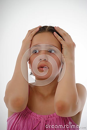 Girl in pink clutching her head child Stock Photo