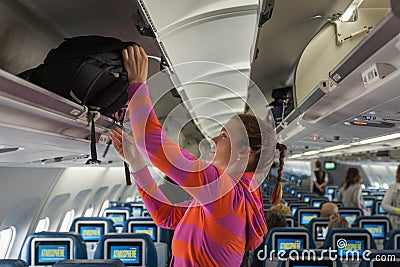 The young girl placed her hand luggage Stock Photo