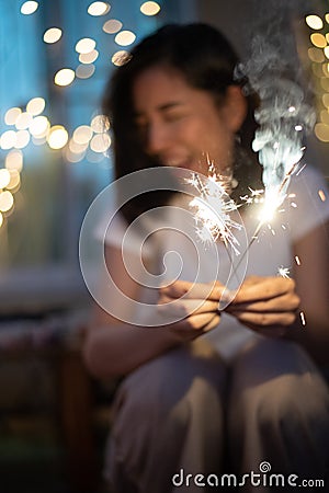 Young girl play a sparkle stick firework Stock Photo