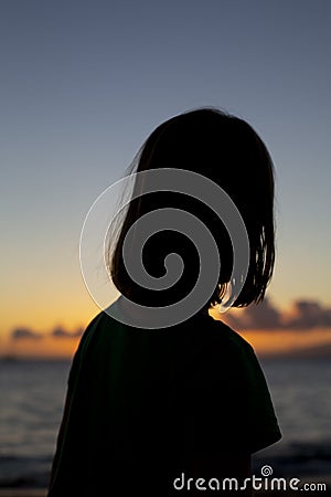 A young girl playing on a beach in Maui Stock Photo