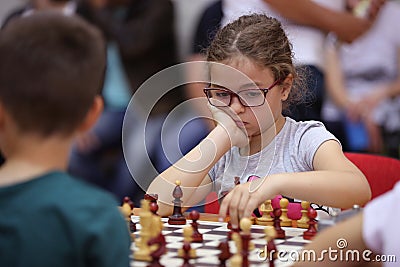 Young girl playing chess Editorial Stock Photo