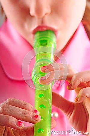 Young girl playing recorder Stock Photo