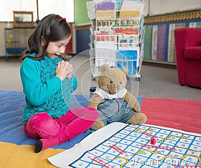 Young Girl Playing Snakes and Ladders. Stock Photo