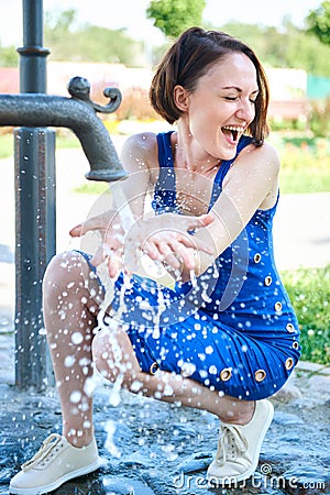 Young girl playing with water squirt and making splashes Stock Photo