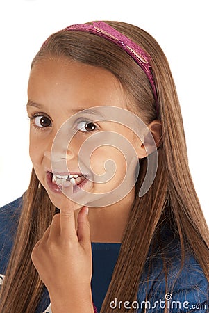 Young girl pointing to lost tooth in her mouth Stock Photo