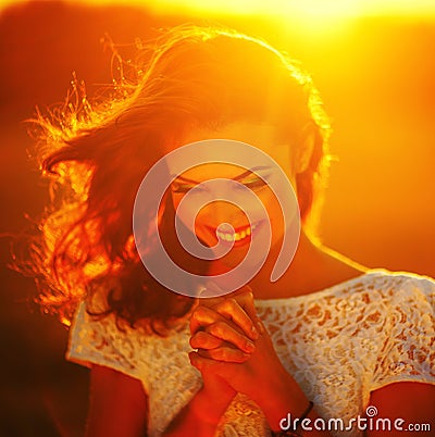 A young girl prays Stock Photo