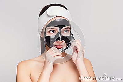 Young girl with purifying black face mask Stock Photo