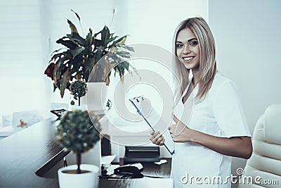 Young Girl at Reception of Modern Beauty Clinic. Stock Photo