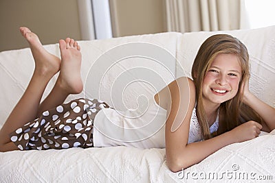 Young Girl Relaxing On Sofa At Home Stock Photo