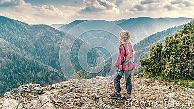 Young girl on a rocky clif Stock Photo