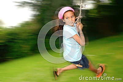 Young girl on rope swing Stock Photo