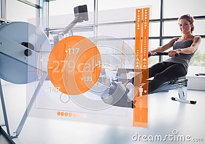 Young girl on rowing machine with futuristic interface showing calories Stock Photo