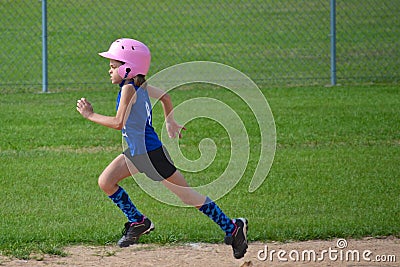 Young Girl Running Bases in Softball Stock Photo