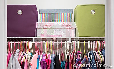 Bright and colorful neatly organized girl`s closet. Stock Photo