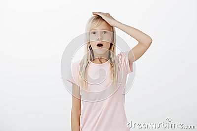 Young girl shocked realising truth about Santa. Portrait of stunned and amazed adorable female kid with blond hair Stock Photo