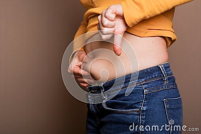 Young girl shows her obesity Stock Photo