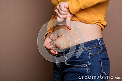 Young girl shows her obesity Stock Photo