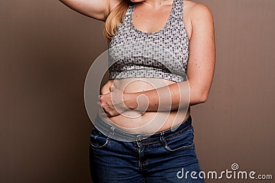 Young girl shows her obesity Stock Photo