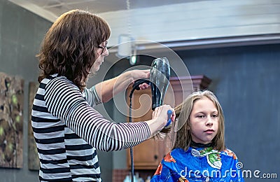 Young girl has her hair styled Stock Photo