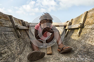 Young girl sitting in canoe in Honduras Editorial Stock Photo