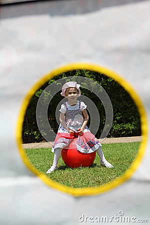 Young girl sitting on red fitness - framed Stock Photo