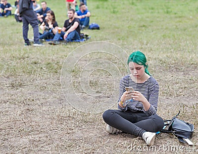 Young girl with smartphone. Atlas Weekend Festival in Kiev, Ukraine Editorial Stock Photo