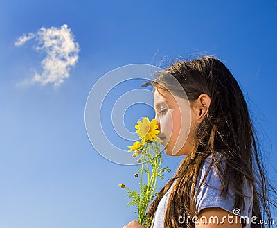 Young girl smelling flowers Stock Photo