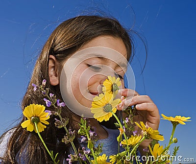 Young girl smelling flowers Stock Photo