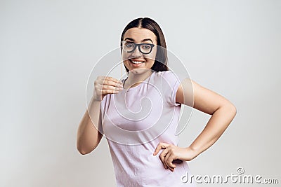 Young girl smiles in sham glasses. Stock Photo