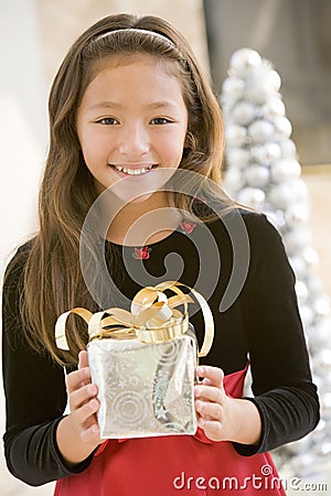 Young Girl Smiling,Holding Christmas Gift Stock Photo