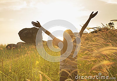 Young girl spreading hands with joy and inspiration Stock Photo