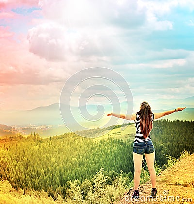 Young girl spreading hands with joy and inspiration Stock Photo